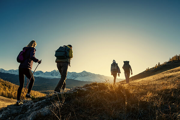 Group Walking With Sunset